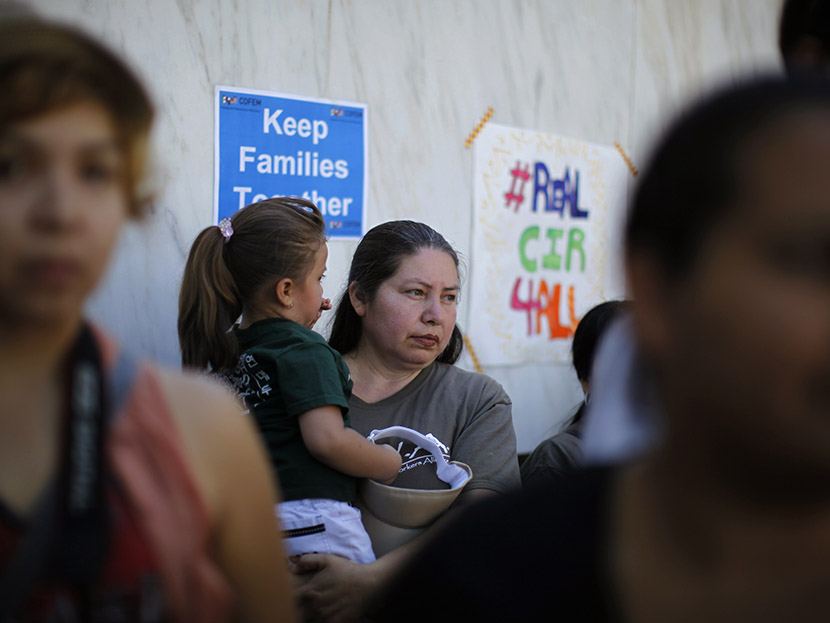People listen to a broadcast of the debate in Congress at a 24-hour vigil calling on Congress to pass immigration reform in Los Angeles, June 27, 2013.  (Photo by Lucy Nicholson/Reuters)