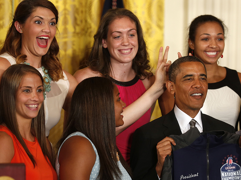 Stefanie Dolson (top left), NCAA women's basketball 2013 national champions player from the University of Connecticut, puts bunny ears over U.S. President Barack Obama during a ceremony to honor the team in the East Room at the White House in...