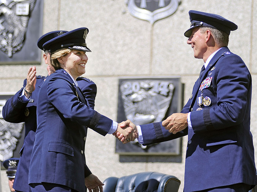 Newly-named superintendent of the United States Air Force Academy Lt. Gen. Michelle Johnson shakes hands with Lt. Gen. Mike Gould after being recognized during a change of command ceremony at the Academy in Colorado, August 12, 2013 (Photo by Sarah...