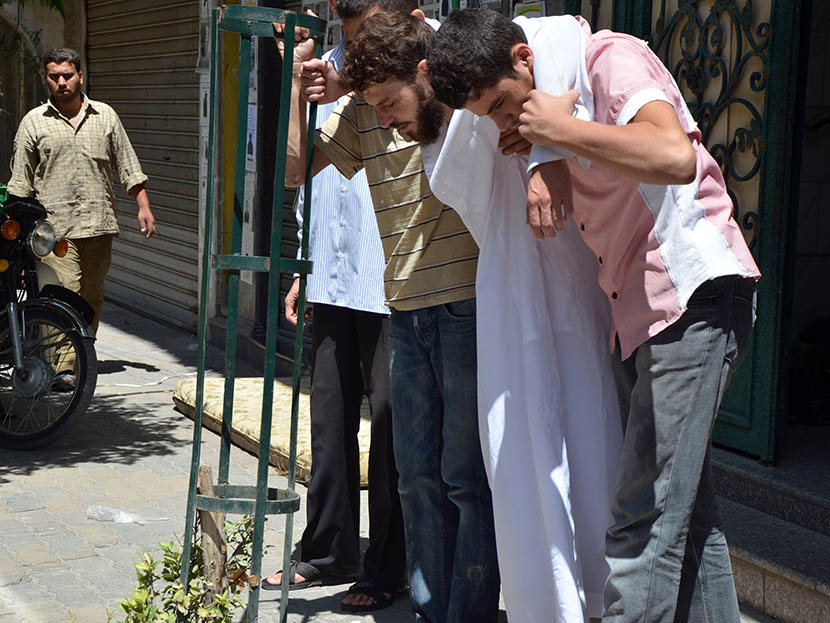 Survivors from what activists say is a gas attack are seen along a street in the Duma neighbourhood of Damascus