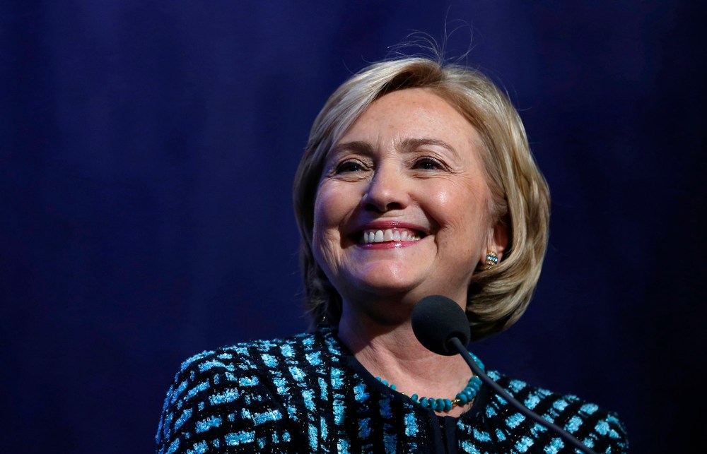 Hillary Clinton smiles as she introduces former U.S. President Bill Clinton and U.S. President Barack Obama to discuss healthcare reform at the Clinton Global Initiative in New York September 24, 2013.