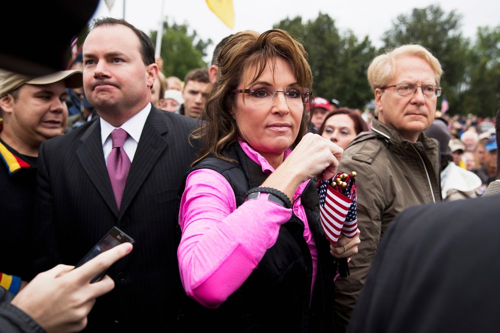 Sarah Palin hands out American Flags to protesters during the "Million Vet March on the Memorials" in Washington, Oct. 13, 2013.