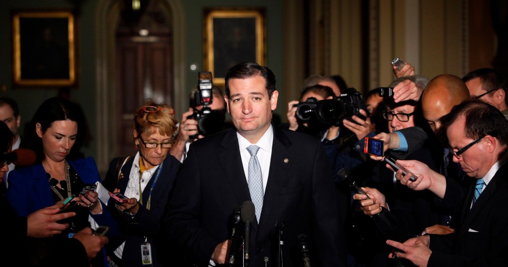 Reporters gather around U.S. Senator Ted Cruz as he talks to reporters after a Republican Senate caucus meeting at the U.S. Capitol in Washington October 16, 2013.