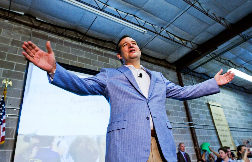 U.S. Senator Ted Cruz gestures on stage as he is welcomed home by supporters in Houston, October 21, 2013.