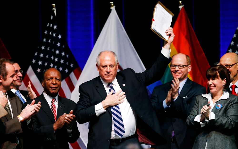 Illinois Governor Pat Quinn holds up the Religious Freedom and Marriage Fairness Act after signing it into law, Nov. 20, 2013.