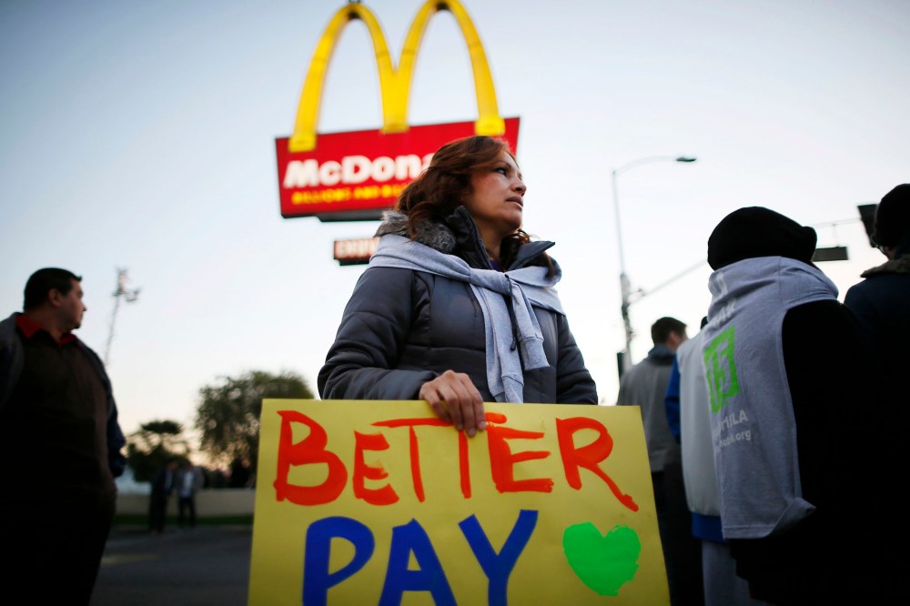 Protesters march outside McDonald's in Los Angeles, California, December 5, 2013.