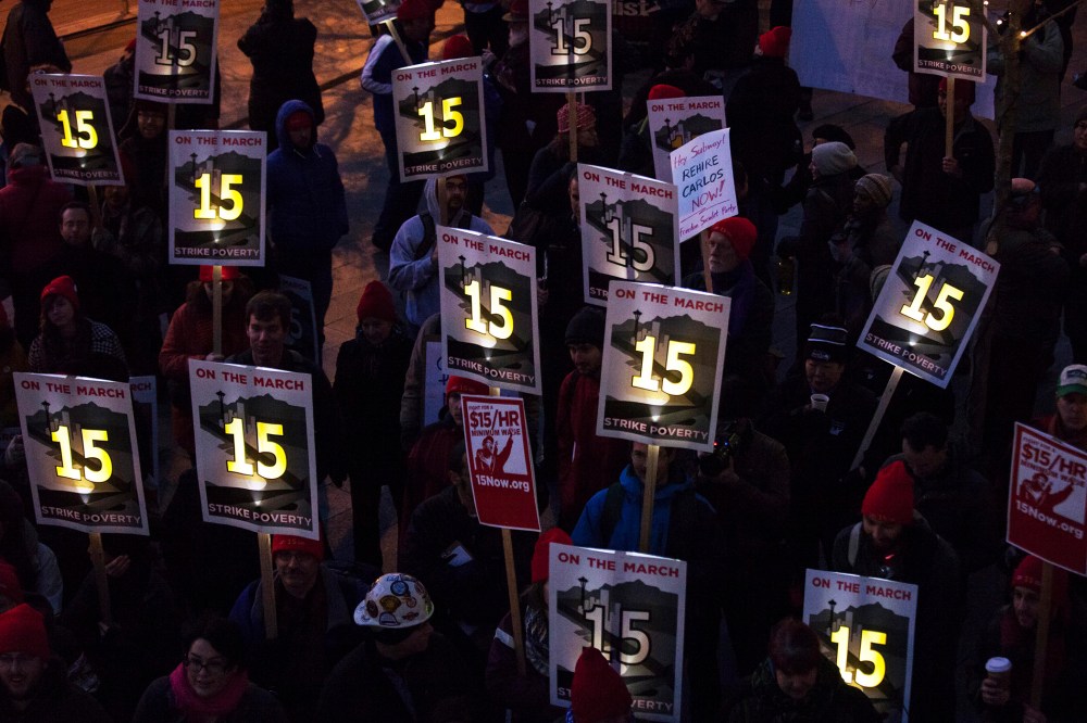 Demonstrators stage a rally to raise the hourly minimum wage to $15 for fast-food workers at City Hall in Seattle, Washington, Dec. 5, 2013.