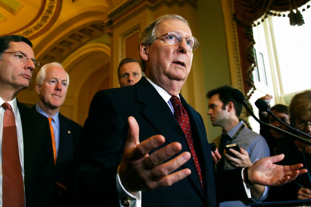U.S. Senate Minority Leader Mitch McConnell (R-KY) speaks to the media following a Senate cloture vote on budget bill on Capitol Hill in Washington, Dec. 17, 2013.
