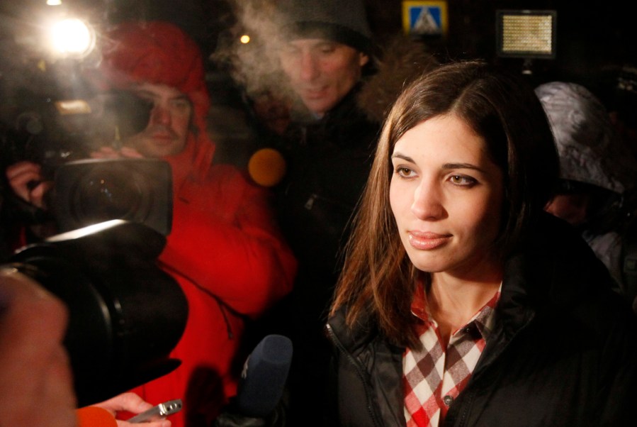 Pussy Riot member Nadezhda Tolokonnikova (R) speaks to the media after she was released from prison in Krasnoyarsk, Dec. 23, 2013.