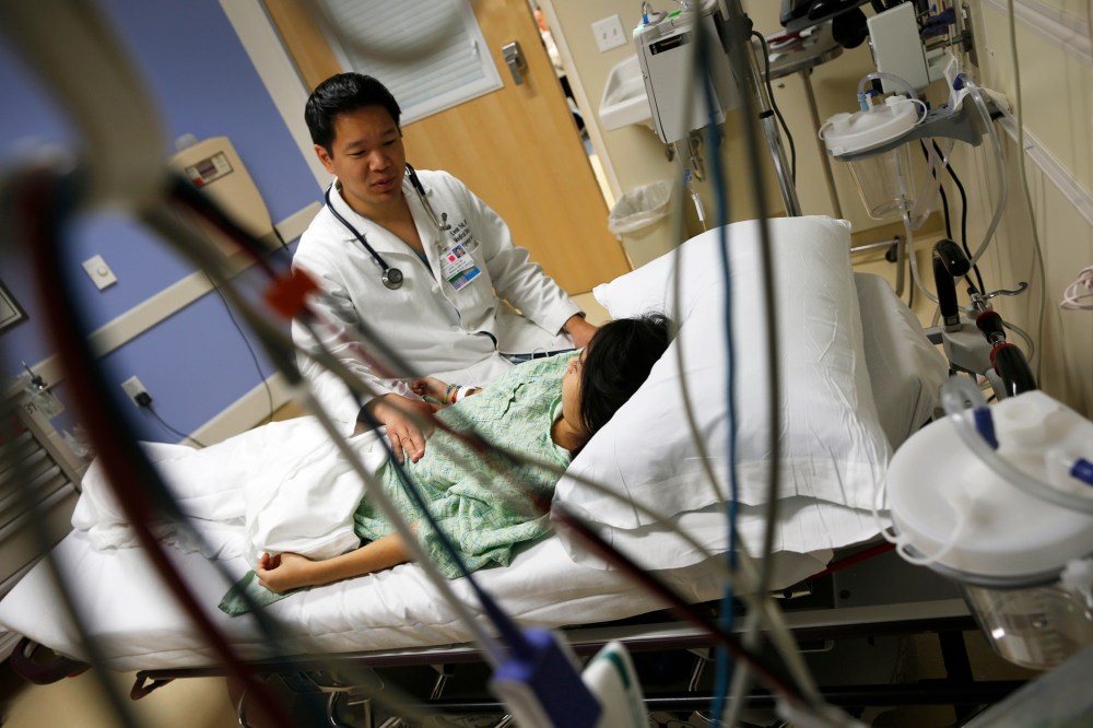 Dr. Leon Yeh speaks with a patient in the Emergency Room at OSF Saint Francis Medical Center in Peoria, Ill., Nov. 26, 2013.