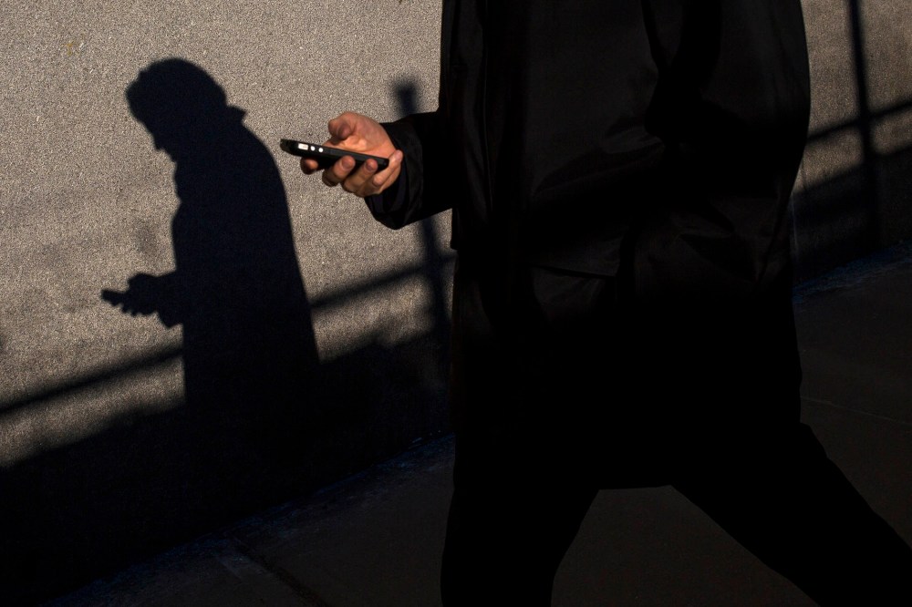 A commuter uses his mobile phone in New York
