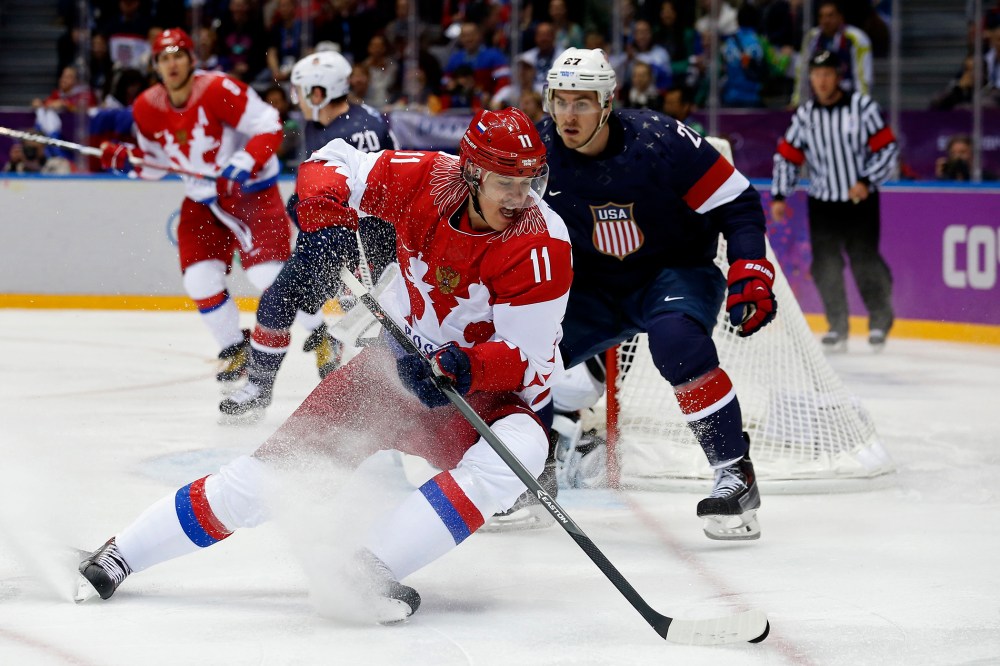 Russia's Yevgeni Malkin (L) spins away from Team USA's Ryan McDonagh during the first period of their men's preliminary round ice hockey game, Feb. 15, 2014, in Sochi, Russia.