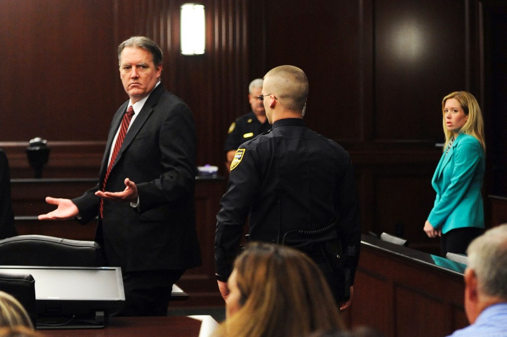 Michael Dunn raises his hands in disbelief as he looks at his parents after the verdicts were announced in his trial in Jacksonville, Florida Feb. 15, 2014.