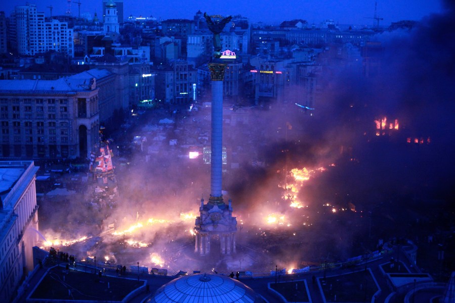 Smoke rises above Independence Square during anti-government protests in central Kiev