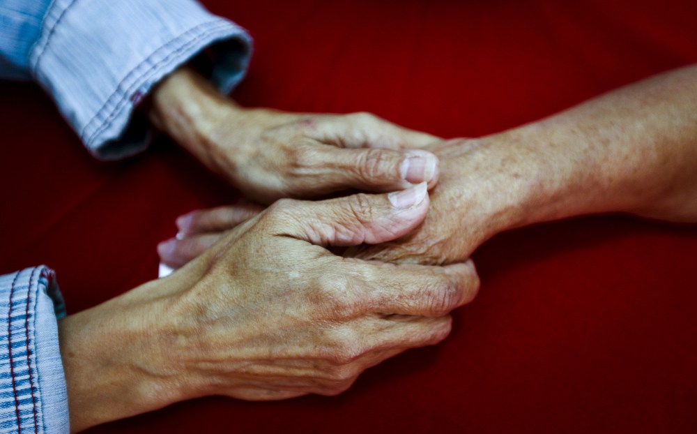 Rosa Elba Lacosta Sanchez Del Campo (L), 57, holds the hand of her mother Caridad Sanchez Del Campo Matos, 83, from Cuba, in La Galena, on the Spanish Canary island of Tenerife, Spain, April 1, 2015. (Photo by Santiago Ferrero/Reuters)