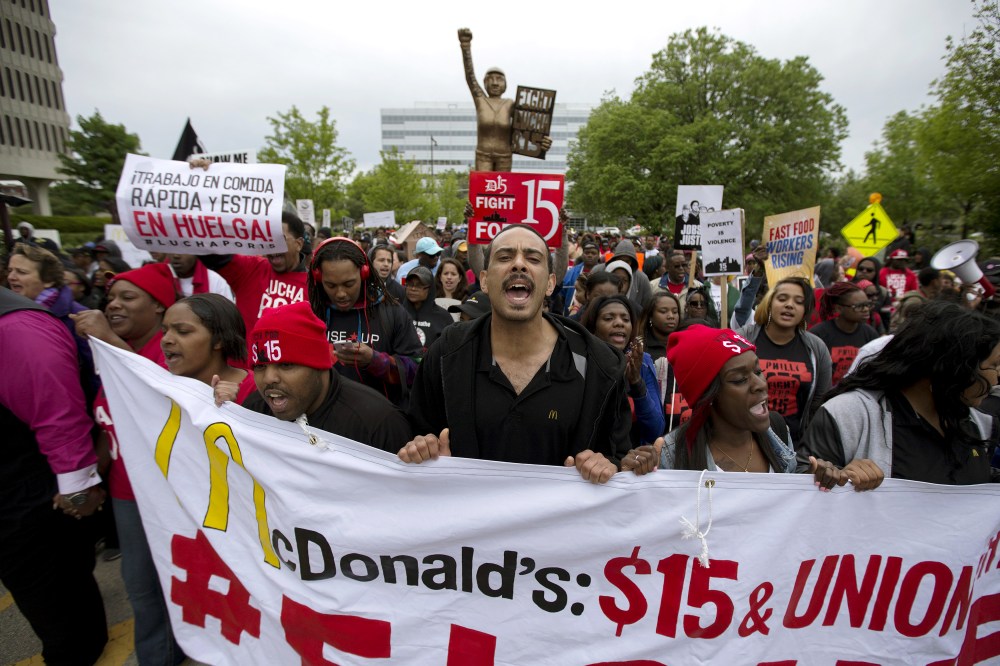 People protest outside of the McDonald's headquarters in Oak Brook, Ill., May 20, 2015. The demonstrators were calling for higher wages and better work conditions. (Photo by Andrew Nelle/Reuters)