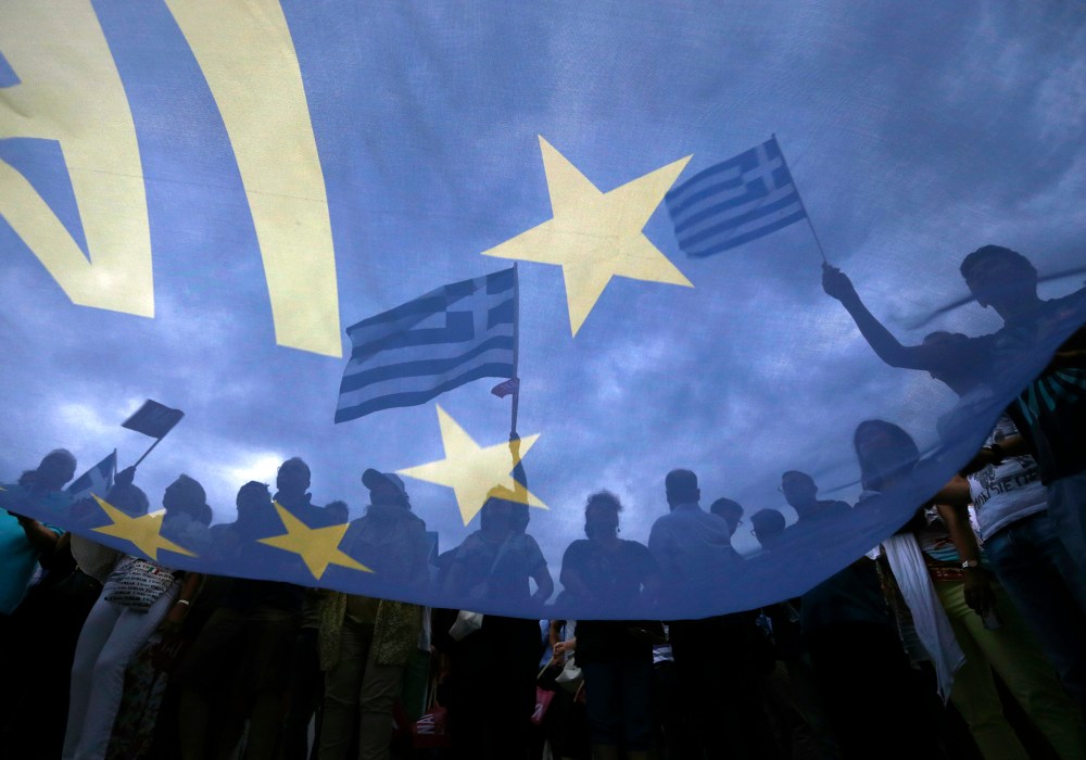 Pro-Euro protestors hold Greek national flags during a pro-Euro rally in front of the parliament building, in Athens, Greece, June 30, 2015. (Photo by Yannis Behrakis/Reuters)