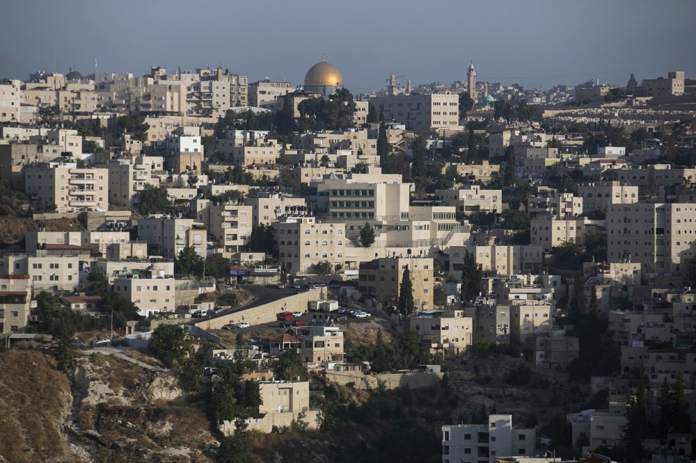 The Arab East Jerusalem neighbourhood of Ras al-Amud is seen in front of the Dome of the Rock