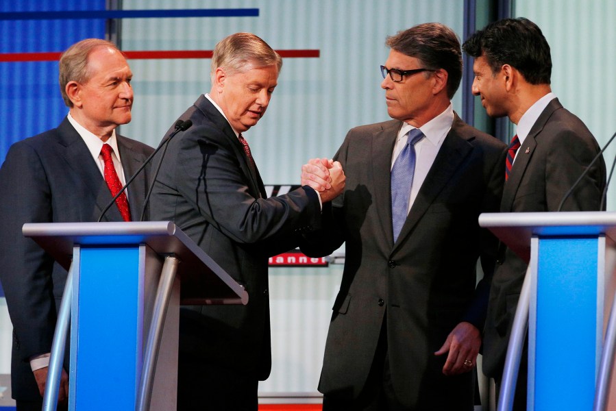 Former Virginia Governor Jim Gilmore (L) and former Texas Governor Rick Perry (2nd from R) will not be attending the upcoming lower-polling forum. Cleveland, Ohio, August 6, 2015. (Photo by Brian Snyder/Reuters)