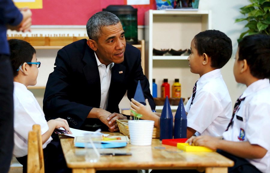 U.S. President Barack Obama greets students on a tour of the Dignity for Children Foundation, an education program for refugee and low-income children, in Kuala Lumpur, Malaysia, Nov. 21, 2015. (Photo by Jonathan Ernst/Reuters)