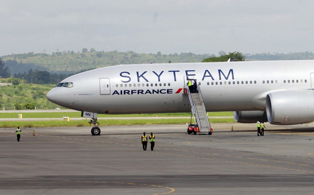 Airport workers are seen near the Air France Boeing 777 aircraft that made an emergency landing is pictured at Moi International Airport in Kenya's coastal city of Mombasa, Dec. 20, 2015. (Photo by Joseph Okanga/Reuters)