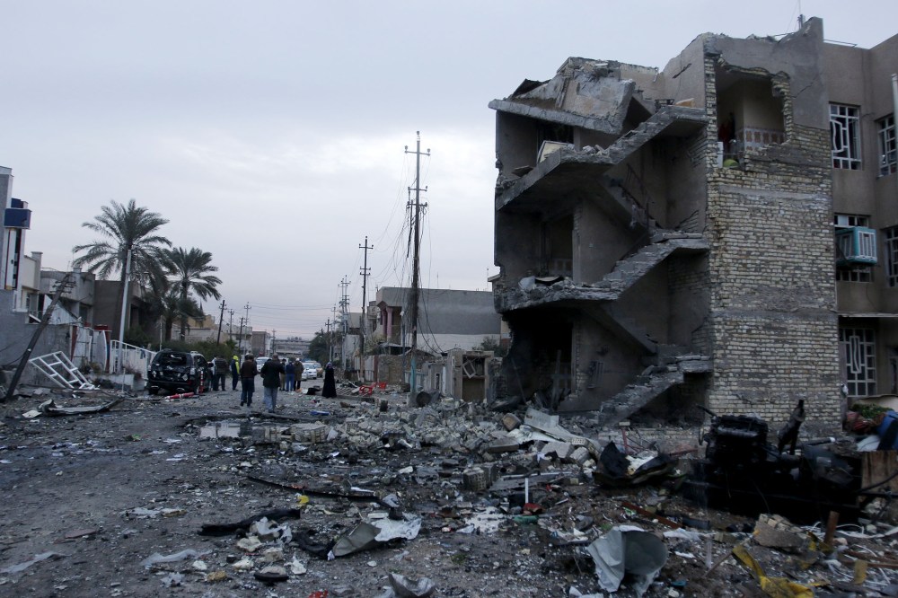 People gather at the site of a car bomb blast in New Baghdad, Jan. 12, 2016. (Photo by Khalid al Mousily/Reuters)