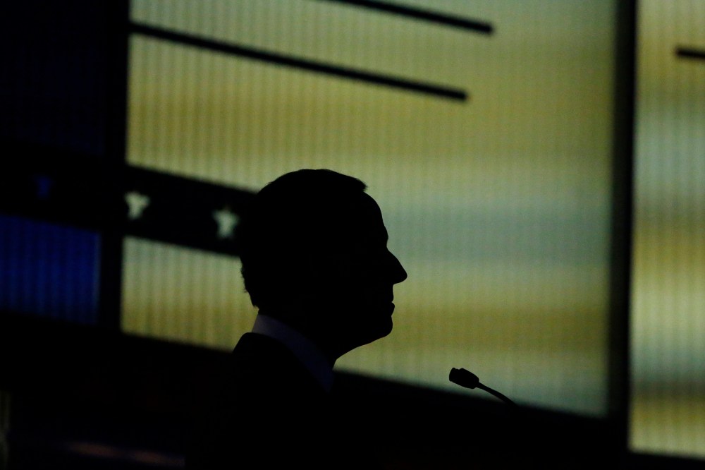 Republican presidential candidate and former Senator Rick Santorum is silhouetted against the backdrop during the undercard debate held by Fox News in Des Moines, Iowa, Jan. 28, 2016. (Photo by Carlos Barria/Reuters)