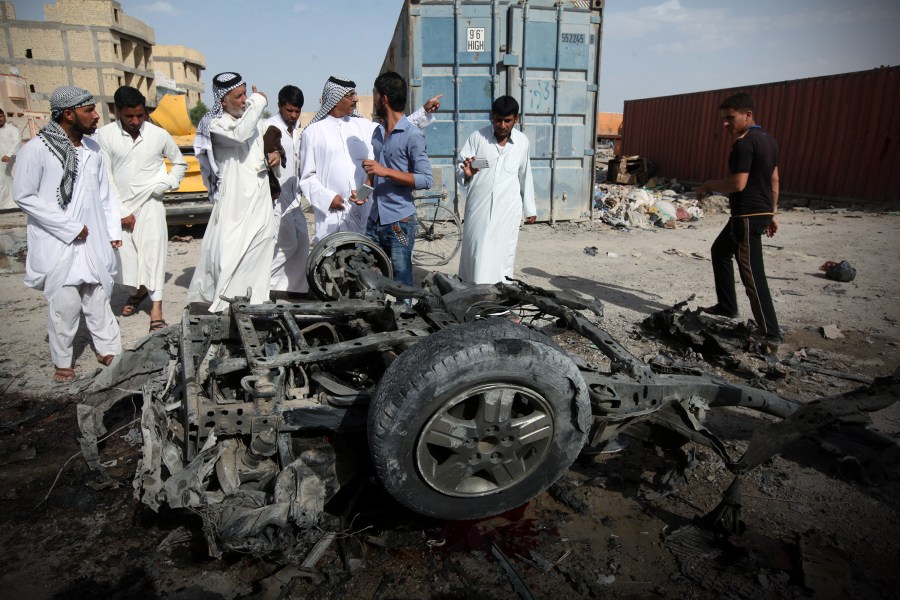 Civilians gather at the site of a car bomb attack in Samawa, south of Baghdad, May 1, 2016. (Photo by Alaa Al-Marjani/Reuters)