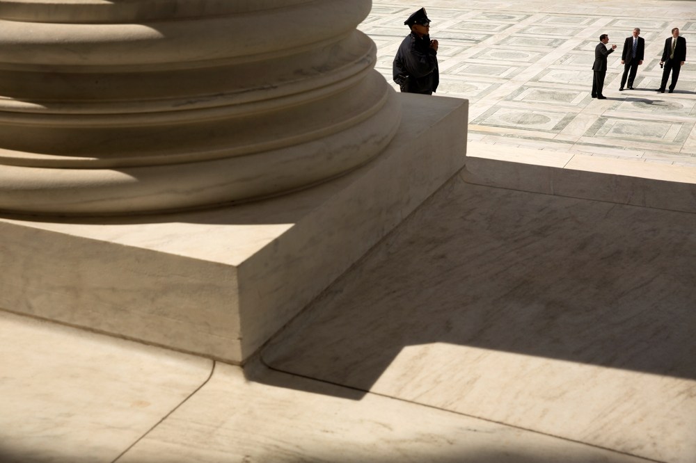 A guard stands on the steps of the U.S. Supreme Court building in Washington, Oct. 5, 2015. (Photo by Jonathan Ernst/Reuters)
