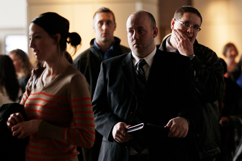 A job seeker (L) makes her pitch to a recruiter while others wait their turn at the Colorado Hospital Association health care career fair in Denver April 9, 2013.