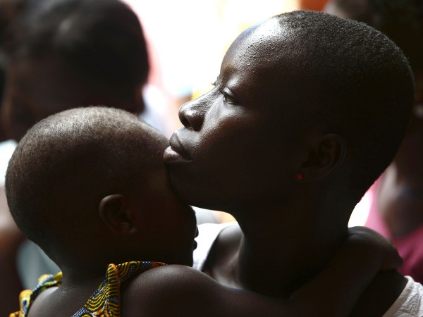 Woman and her child attend a talk on sexual and domestic violence and HIV/AIDS prevention in Lome