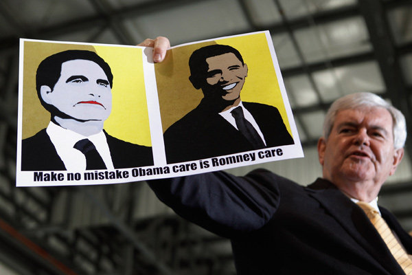 Newt Gingrich holding up a sign made by a supporter during a campaign rally at the Tampa Jet Center on Monday.