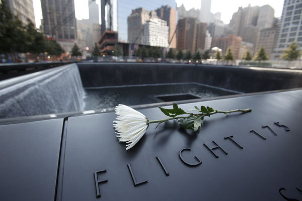 A flower sitting on one of the panels displaying names of victims at the 9/11 memorial in New York on Monday.