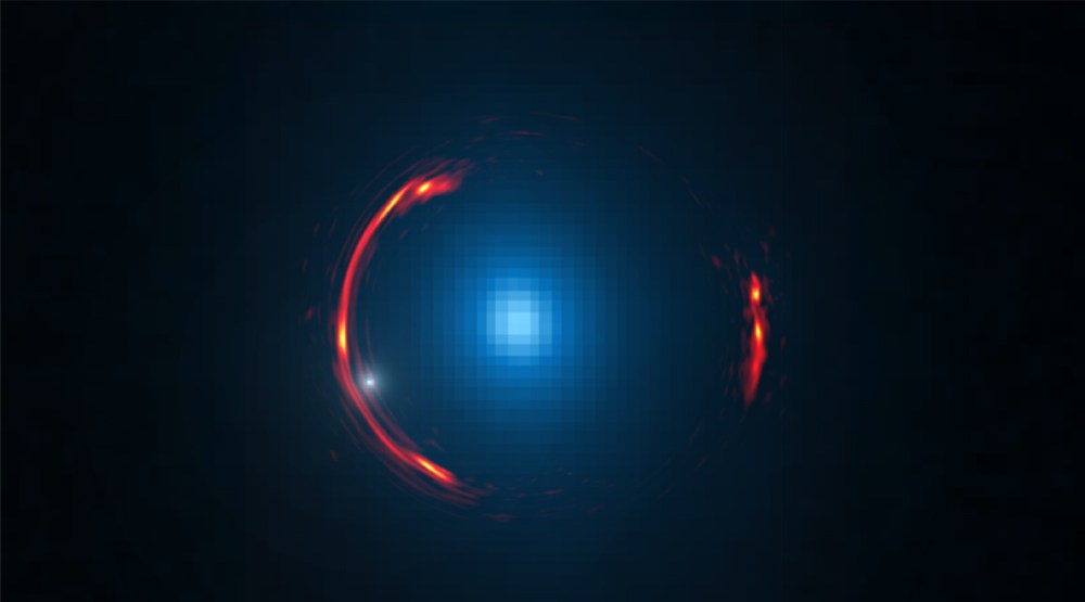 Composite image of the gravitational lens SDP.81 showing the distorted ALMA image of the more distant galaxy (red arcs) and the Hubble optical image of the nearby lensing galaxy (blue center object).