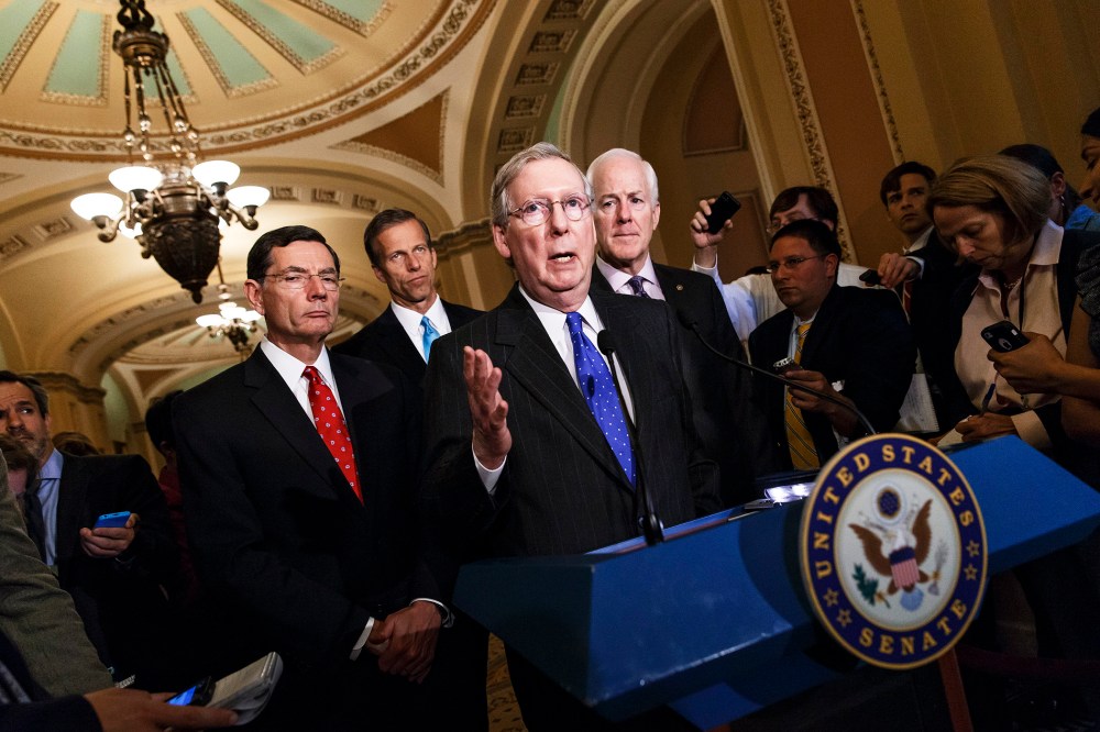 Senate Minority Leader Mitch McConnell and GOP lawmakers talk to reporters after a GOP caucus meeting, April 29, 2014.