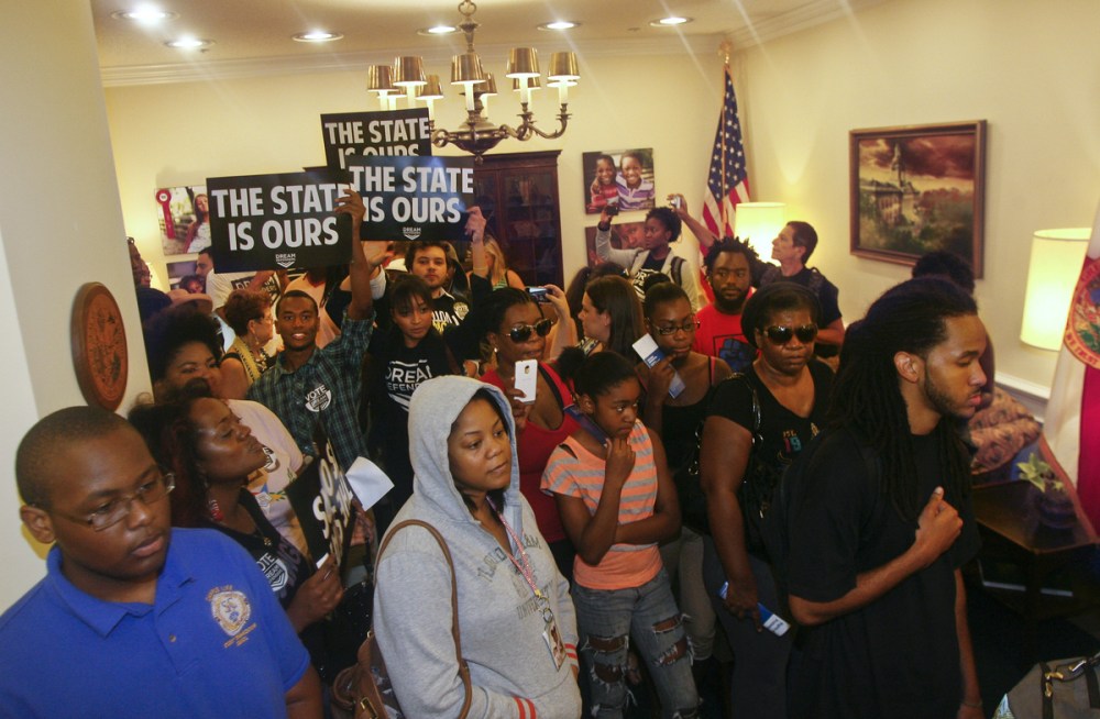Protesters crowd into Florida Gov. Rick Scott's office Tuesday July 16, 2013, at the Capitol in Tallahassee, Fla. Dream Defenders organized a sit-in of Florida Gov. Rick Scott's office in response to the not guilty verdict in the trial of George...