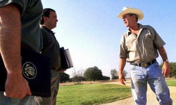 George W. Bush talks with aides on Aug. 6, 2001, the day he was briefed on a memo titled, "Bin Laden Determined to Strike in US."