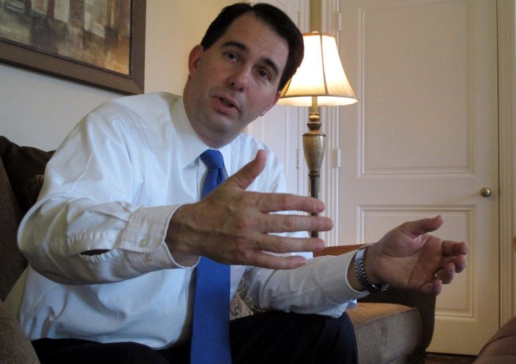 In this Thursday, Dec. 22, 2011 photo taken in Maple Bluff, Wis., Wisconsin Gov. Scott Walker talks about progress that's been made on his 2010 campaign pledge to add 250,000 jobs by 2015. In nearly a year the state has added just more than 16,000 jobs...