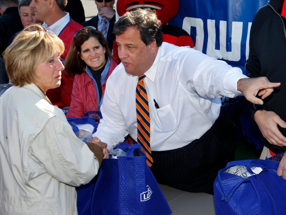 As New Jersey first lady, Mary Pat Christie, center, looks on in Toms River, N.J., Wednesday, Nov. 21, 2012, Gov. Chris Christie tells Nannette Derillo, of Toms River, N.J., to talk to one of his aides about a problem. The Christies joined other...
