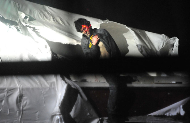 Boston bombing suspect Dzhohkar Tsarnaev emerging from a boat on April 19, 2013 in Watertown, Massachusetts. (Photo by Sgt. Sean Murphy/Boston Magazine)