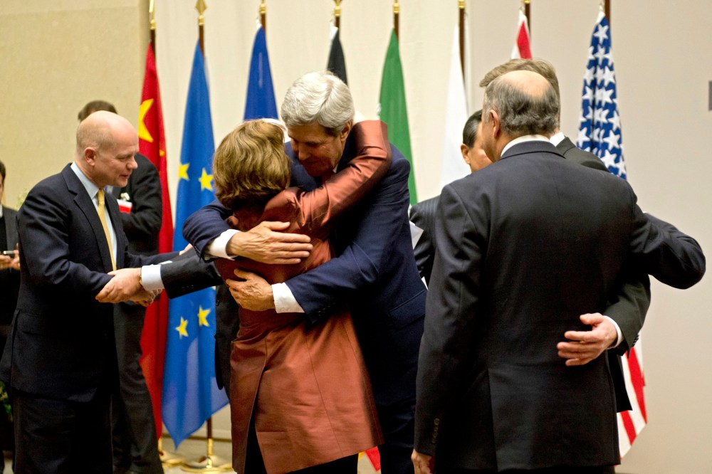 U.S. Secretary of State John Kerry, center, embraces EU foreign policy chief Catherine Ashton, during a ceremony at the United Nations after an agreement was reached on Iran's nuclear program, in Geneva, Switzerland, Sunday, Nov. 24, 2013.
