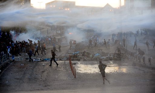 Protestor clash with Turkish riot police using water cannons between Taksim and Besiktas in Istanbul on June 3, 2013 during a demonstration against the demolition of the park. Turkish police on June 1 began pulling out of Istanbul's iconic Taksim...