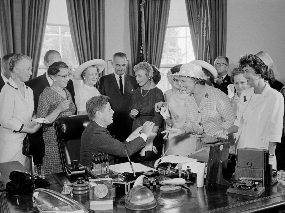 President Kennedy is seen during a ceremony at the White House in which he signed into law a bill aimed at assuring women of paychecks equal to those of men doing the same work on June 10, 1963 in Washington, DC. (Photo by Bettmann/Corbis)