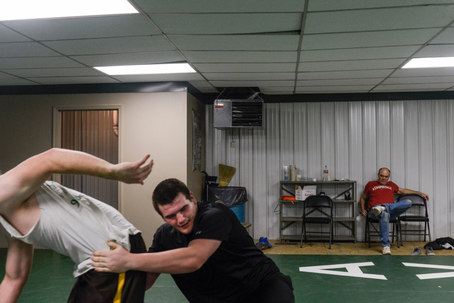 Mike Sisco (17) at high school wrestling practice in Quinton, Okla. Mike and his wife Autumn had a child when she was 17 and he was 15.