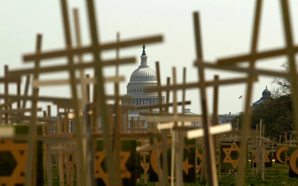 With the U.S. Capitol in the background, crosses symbolizing grave markers are placed upon the National Mall in Washington April 11, 2013. The PICO National Network's Lifelines to Healing and Sojourners are holding a 24-hour vigil featuring a gathering...