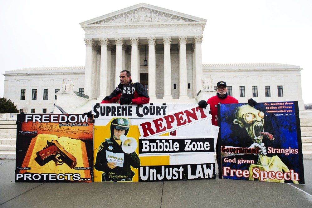 Pro-life demonstrators stand outside the US Supreme Court following oral arguments in the case of McCullen v. Coakley, Jan. 15, 2014.