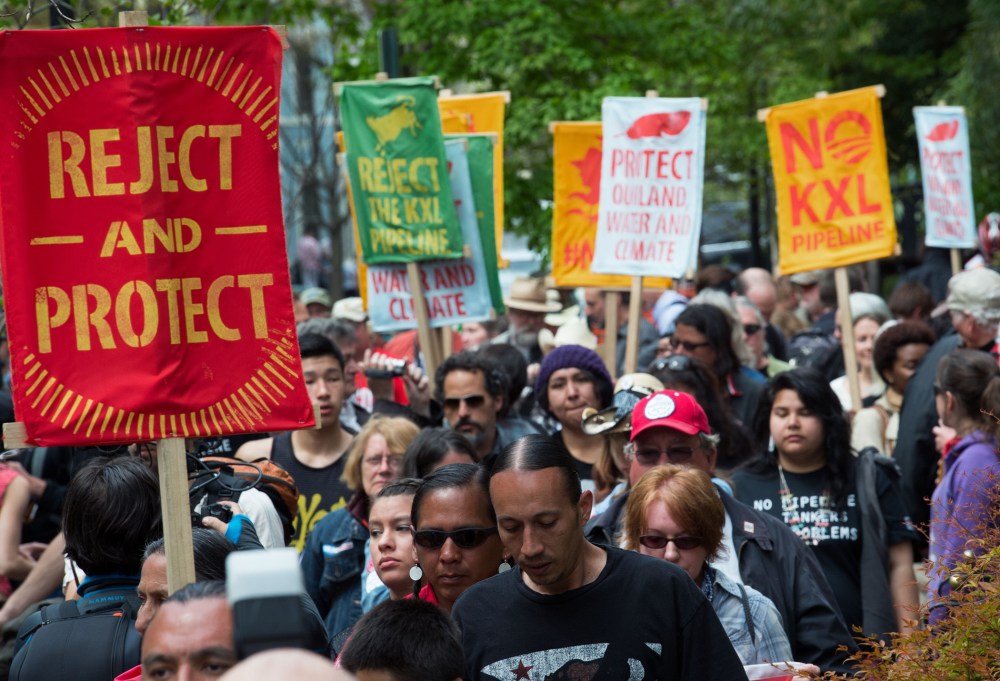Members of the The Cowboy and Indian Alliance protest across the street from US Secretary of State John Kerry's house, April 25, 2014.