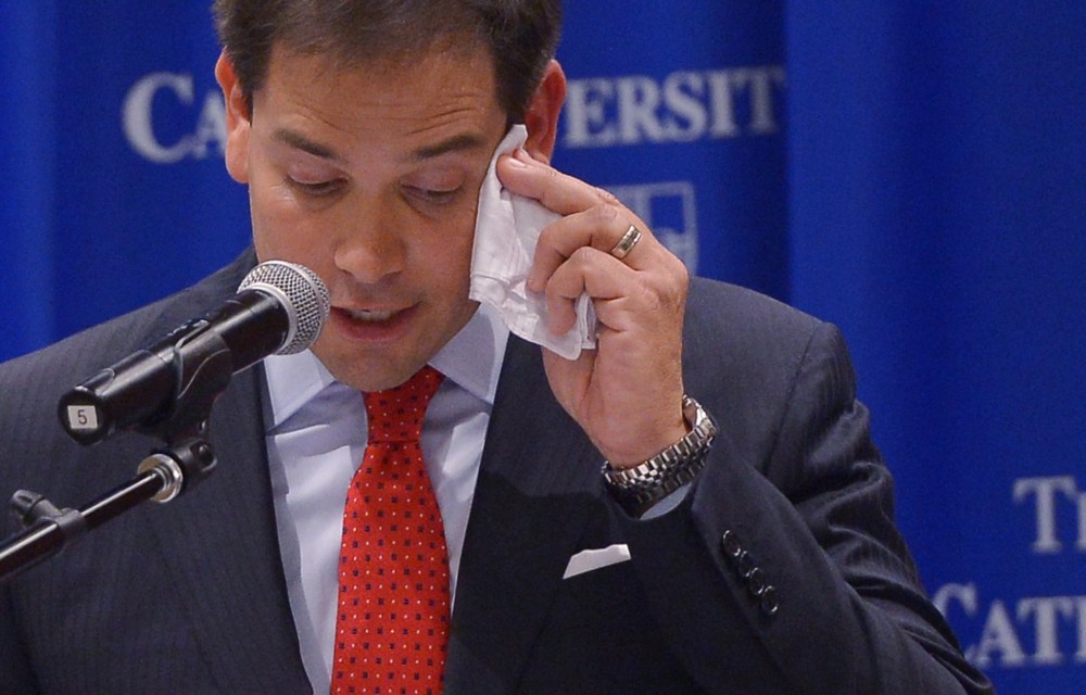 Senator Marco Rubio, R-FL, wipes his brow as he speaks during a discussion on the American family and cultural values." at Catholic University on July 23, 2014 in Washington, D.C.