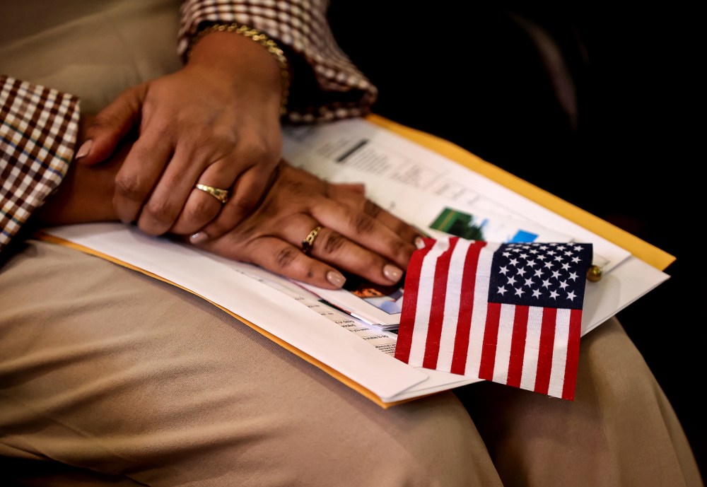 A new citizen holds an American flag during a naturalization ceremony
