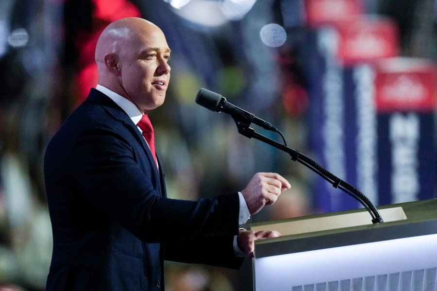 Brian Mast speaks at a podium onstage